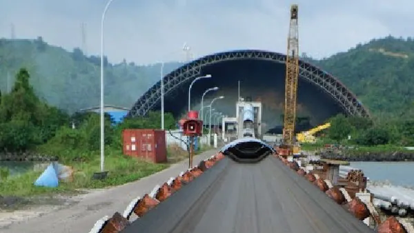 Barge loading conveyor system leading to a dome storage facility engineered by PT Rexline Engineering Indonesia