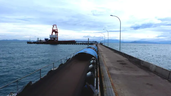 Barge loading conveyor system leading to a dome storage facility engineered by PT Rexline Engineering Indonesia (view 5)