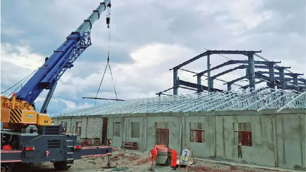 Crane lifting a tower structure during site installation and commissioning by PT Rexline Engineering Indonesia (view 2)